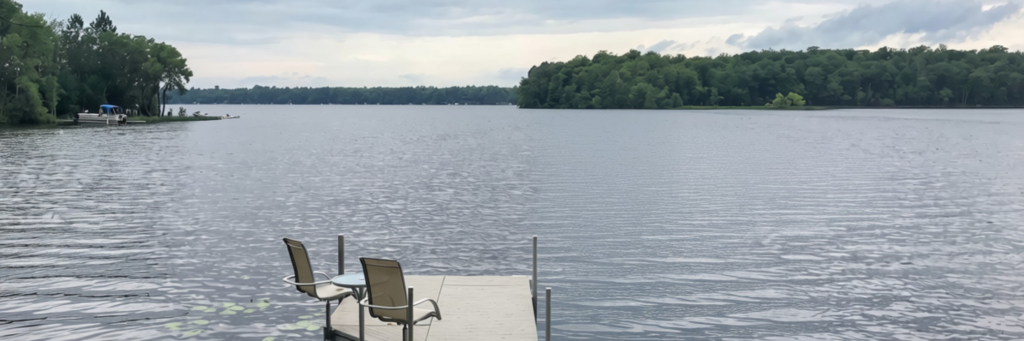 Places to Explore Scenic view of Lake Minnewawa with a wooden dock and calm water under a clear sky.